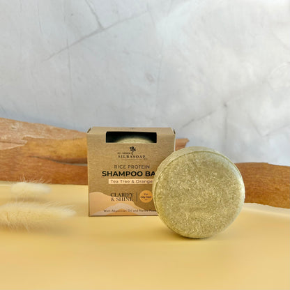 Clarify & Shine Shampoo Bar displayed with natural props